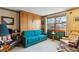 Bedroom with a built-in Murphy bed, decorative wallpaper, and two windows providing natural light at 2013 S Holland St, Lakewood, CO 80227