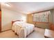 Bedroom with a window, a bed with a quilt, and vintage decor at 2013 S Holland St, Lakewood, CO 80227