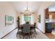 Formal dining room with chandelier, round table, decorative rug, and a large window view at 2013 S Holland St, Lakewood, CO 80227