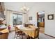 Bright dining room with traditional decor, a large window, and access to an adjacent kitchen at 2013 S Holland St, Lakewood, CO 80227