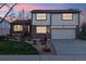 Charming two-story home with brick accents, a manicured lawn, and attached two-car garage at 2013 S Holland St, Lakewood, CO 80227