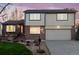 Charming two-story home with a brick facade, well-manicured lawn, and an attached two-car garage at 2013 S Holland St, Lakewood, CO 80227