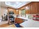 Well-lit kitchen features wooden cabinets, stainless steel appliances, and a window over the sink at 2013 S Holland St, Lakewood, CO 80227