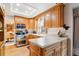 Well-lit kitchen features wood cabinets, updated appliances, and a bright window that offers abundant natural light at 2013 S Holland St, Lakewood, CO 80227