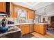Updated kitchen featuring wood cabinets, bright countertops, stainless steel appliances, and views to the eating area at 2013 S Holland St, Lakewood, CO 80227