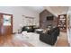 Cozy living room with brick fireplace, built in shelves and plush couches at 2013 S Holland St, Lakewood, CO 80227