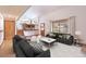 Open concept living area with vaulted ceiling, wood floors, and view of kitchen and backyard at 2013 S Holland St, Lakewood, CO 80227