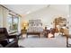 Bright living room featuring a large window, vaulted ceilings, and comfortable seating arrangements at 2013 S Holland St, Lakewood, CO 80227
