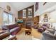 Cozy living room with a brick fireplace, high ceilings, and natural light, perfect for gatherings and relaxation at 2013 S Holland St, Lakewood, CO 80227