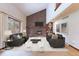 Bright living room featuring a brick fireplace, vaulted ceilings, and comfortable seating at 2013 S Holland St, Lakewood, CO 80227