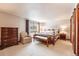 Comfortable main bedroom features a decorative wood bed frame and ample natural light at 2013 S Holland St, Lakewood, CO 80227