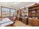 Bright office with built-in bookshelves, a large window, and a comfortable desk setup, ideal for work or study at 2013 S Holland St, Lakewood, CO 80227