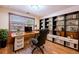 Home office featuring a built-in bookshelf, a wooden desk, and an ergonomic chair at 2013 S Holland St, Lakewood, CO 80227