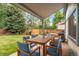 Inviting outdoor patio with dining table, seating, and views of the spacious, fenced backyard at 2013 S Holland St, Lakewood, CO 80227
