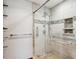 Modern walk-in shower with glass enclosure, sleek fixtures, and tiled walls, providing a luxurious and accessible bathing experience at 2013 S Holland St, Lakewood, CO 80227