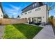 Backyard with modern patio, well-kept lawn, and sleek architectural exterior details at 380 S Humboldt St, Denver, CO 80209