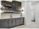 Stylish bar area with sleek cabinetry, beverage cooler, and display shelving for glassware at 380 S Humboldt St, Denver, CO 80209