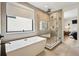 Bright bathroom featuring a contemporary tub, a glass enclosed shower and an adjacent entry to the Main bedroom at 380 S Humboldt St, Denver, CO 80209