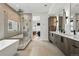 The bathroom features a tub, shower and double vanity with sleek fixtures, cabinetry and entry to the Main bedroom at 380 S Humboldt St, Denver, CO 80209