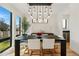 Bright dining area with a stylish chandelier, hardwood floors, and large windows for natural light at 380 S Humboldt St, Denver, CO 80209