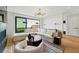 Comfortable living room featuring a large sectional sofa, stylish decor, and sliding glass doors at 380 S Humboldt St, Denver, CO 80209