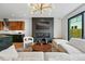 Open-concept living room with fireplace, modern lighting, and hardwood floors at 380 S Humboldt St, Denver, CO 80209