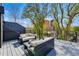 Relaxing outdoor deck featuring sleek sofas, decorative bowl, and views of mature trees at 380 S Humboldt St, Denver, CO 80209