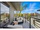 Balcony seating area with comfortable chairs and table, surrounded by black metal railings at 380 S Humboldt St, Denver, CO 80209