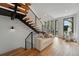 Modern staircase with wood treads, black metal railings, and natural light at 380 S Humboldt St, Denver, CO 80209