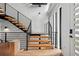 Modern staircase featuring wood treads, black metal railings, and open design at 380 S Humboldt St, Denver, CO 80209