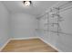 Unfinished walk-in closet with white metal shelving and light colored flooring at 6526 S Elmwood St, Littleton, CO 80120