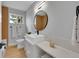 Modern bathroom with a round mirror and white countertop at 6526 S Elmwood St, Littleton, CO 80120