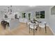Bright kitchen with island, stainless steel appliances, and an adjacent dining area at 6526 S Elmwood St, Littleton, CO 80120