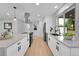 Bright, modern kitchen with stainless steel appliances, a large island, and stylish fixtures at 6526 S Elmwood St, Littleton, CO 80120