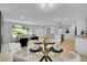 Open living space with a modern kitchen, dining area, and living room with fireplace at 6526 S Elmwood St, Littleton, CO 80120