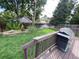 Landscaped backyard with a deck and grill, perfect for outdoor entertaining and relaxation at 540 S Forest St # A2, Denver, CO 80246