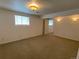 Finished carpeted basement bedroom with natural light and sconce lighting fixtures at 540 S Forest St # A2, Denver, CO 80246