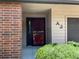Entryway with red security door and view of brick exterior at 540 S Forest St # A2, Denver, CO 80246