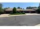 Inviting exterior view of townhouse featuring attached garages, lush lawn, and mature trees at 540 S Forest St # A2, Denver, CO 80246