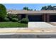 Exterior view of townhouse featuring attached garage, brick accents, and manicured lawn at 540 S Forest St # A2, Denver, CO 80246