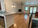 Open-concept living room with wood flooring, stone fireplace, and sliding door to the back patio at 540 S Forest St # A2, Denver, CO 80246