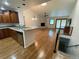 Bright living room featuring wood floors, stone fireplace, with kitchen bar at 540 S Forest St # A2, Denver, CO 80246