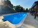 Community pool featuring clear blue water, lounge chairs, and shaded seating areas at 540 S Forest St # A2, Denver, CO 80246