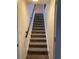Carpeted staircase with a handrail providing safe and easy access to the upper level at 540 S Forest St # A2, Denver, CO 80246