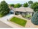 Aerial view of a lovely single-story home with well-kept landscaping and a driveway at 1735 Crestone Dr, Longmont, CO 80504