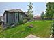 Well-manicured backyard with lush green lawn, mature landscaping, and covered gazebo, ideal for outdoor relaxation at 1735 Crestone Dr, Longmont, CO 80504