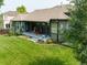 The backyard features a covered patio, healthy lawn, and meticulous landscaping at 1735 Crestone Dr, Longmont, CO 80504