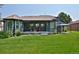 Backyard with covered patio area and well-maintained lawn, ideal for entertaining or relaxing outdoors at 1735 Crestone Dr, Longmont, CO 80504