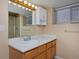Bathroom features a shower, toilet, single sink, cabinets, and window that provides natural light at 1735 Crestone Dr, Longmont, CO 80504
