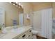 Traditional bathroom with a vanity, mirror, and shower-tub combination with shower curtain at 1735 Crestone Dr, Longmont, CO 80504